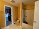 Bathroom with a walk-in closet and a tub with shower at 5241 Waterton Lakes Dr, Indianapolis, IN 46237