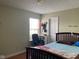 Bedroom features a hardwood floor, natural light, and simple decor at 5241 Waterton Lakes Dr, Indianapolis, IN 46237
