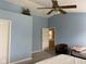 Bright bedroom with vaulted ceiling, light blue walls, and access to a bathroom at 5241 Waterton Lakes Dr, Indianapolis, IN 46237