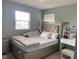 Bright bedroom featuring light-colored walls, a vanity, and ample natural light at 5241 Waterton Lakes Dr, Indianapolis, IN 46237