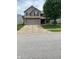Charming two-story home with a two-car garage and inviting curb appeal on a sunny day at 5241 Waterton Lakes Dr, Indianapolis, IN 46237
