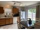 Eat-in kitchen featuring wood cabinets, white appliances, and a sliding glass door to the yard at 5241 Waterton Lakes Dr, Indianapolis, IN 46237