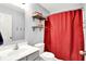 Cozy bathroom features storage shelves and a red shower curtain at 5517 Jona Way, Bargersville, IN 46106