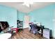 Bright bedroom features wood floors, ceiling fan and sewing machine setup at 5517 Jona Way, Bargersville, IN 46106