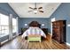 This bedroom boasts hardwood floors, a ceiling fan, and an upholstered storage bench at 5517 Jona Way, Bargersville, IN 46106
