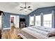 Primary bedroom features a ceiling fan, hardwood floors, and large windows at 5517 Jona Way, Bargersville, IN 46106