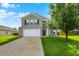 Charming two-story home featuring a manicured lawn and a two-car garage at 5517 Jona Way, Bargersville, IN 46106