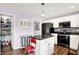 Contemporary kitchen featuring stainless steel appliances and an adjacent laundry area at 5517 Jona Way, Bargersville, IN 46106