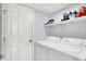 Functional laundry room features modern appliances and ample shelving for storage at 5517 Jona Way, Bargersville, IN 46106