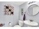 Quaint powder room features a pedestal sink, decorative mirror and playful decor at 5517 Jona Way, Bargersville, IN 46106