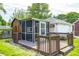 The backyard features a screened-in porch with deck and convenient storage shed next to a detached garage at 5809 N Illinois St, Indianapolis, IN 46208