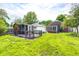 Spacious backyard featuring a screened-in porch with a wooden deck perfect for outdoor entertaining at 5809 N Illinois St, Indianapolis, IN 46208
