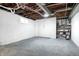 Unfinished basement with painted walls, and concrete floor. Includes shelves for ample storage space at 5809 N Illinois St, Indianapolis, IN 46208