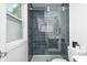 The bathroom showcases a walk-in shower with dark tile and glass door, plus modern fixtures at 5809 N Illinois St, Indianapolis, IN 46208