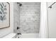 This bathroom features updated fixtures, marble tiling in the shower and neutral paint at 5809 N Illinois St, Indianapolis, IN 46208