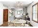 Bright dining area featuring elegant lighting, hardwood floors, and access to a modern kitchen at 5809 N Illinois St, Indianapolis, IN 46208