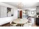 Lovely dining space with elegant lighting and view into the open kitchen and living area at 5809 N Illinois St, Indianapolis, IN 46208