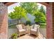 Charming front porch with wicker chairs, brick details, and a view of the yard at 5809 N Illinois St, Indianapolis, IN 46208