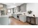 A bright kitchen features gray cabinets, stainless steel appliances, and hardwood floors for a modern look at 5809 N Illinois St, Indianapolis, IN 46208