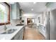 Modern kitchen showcasing light cabinets, stainless appliances, and an open view of the dining area at 5809 N Illinois St, Indianapolis, IN 46208
