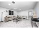 A modern living room with a grey couch, two chairs, and neutral decor at 5809 N Illinois St, Indianapolis, IN 46208