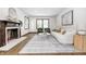 Elegant living room boasting a decorative fireplace, wood floors, and natural light at 5809 N Illinois St, Indianapolis, IN 46208