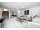 A living room with two chairs, couch, carpet, and stairs in the background at 5809 N Illinois St, Indianapolis, IN 46208
