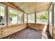 Bright sunroom with wood paneled walls, ceiling, and patterned tile floor at 5809 N Illinois St, Indianapolis, IN 46208
