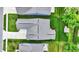 Overhead shot of home featuring gray roof, green grass and landscaping with a view of the driveway and nearby houses at 5850 Lyster Ln, Indianapolis, IN 46239