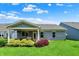 Backyard with green grass and a patio with outdoor seating area, great for entertaining at 5850 Lyster Ln, Indianapolis, IN 46239