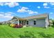 Spacious backyard features lush green lawn, and a covered patio at 5850 Lyster Ln, Indianapolis, IN 46239