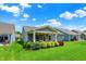 Wide view of the well manicured backyard, patio, and landscaping at 5850 Lyster Ln, Indianapolis, IN 46239