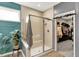 Updated bathroom features a glass-enclosed shower, bench, and open closet at 5850 Lyster Ln, Indianapolis, IN 46239