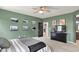 The main bedroom has black and white photographs adorning the calming green colored walls at 5850 Lyster Ln, Indianapolis, IN 46239