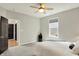 Bright, well-lit bedroom features a ceiling fan, carpet, and a window with ample natural light at 5850 Lyster Ln, Indianapolis, IN 46239