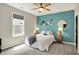 Comfortable bedroom featuring a ceiling fan, a modern accent wall, and ample natural light at 5850 Lyster Ln, Indianapolis, IN 46239