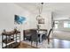 Bright dining area features modern chandelier, banquette seating, and a bar cart for entertaining at 5850 Lyster Ln, Indianapolis, IN 46239