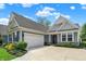 Beautiful home exterior highlighting a two-car garage and elegant stonework at 5850 Lyster Ln, Indianapolis, IN 46239