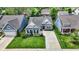 Inviting single-Gathering home with manicured lawn, stone accents, and a long driveway leading to an attached garage at 5850 Lyster Ln, Indianapolis, IN 46239