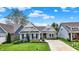 Home features a well-manicured lawn, landscaping, and a welcoming front entrance at 5850 Lyster Ln, Indianapolis, IN 46239