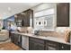 The kitchen features stainless steel appliances, dark cabinets, and stylish backsplash beneath a large window at 5850 Lyster Ln, Indianapolis, IN 46239