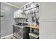 Well-organized laundry room with modern washer and dryer, wooden countertop, and wall-mounted storage at 5850 Lyster Ln, Indianapolis, IN 46239