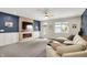 Cozy living room featuring a built-in fireplace with wood paneling, plush carpeting and abundant natural light at 5850 Lyster Ln, Indianapolis, IN 46239