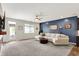 Open living space with neutral finishes, plush carpeting, and ample natural light at 5850 Lyster Ln, Indianapolis, IN 46239