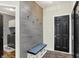 Inviting mudroom with wooden bench and coat hooks features a laundry room to the left and paneled door to the right at 5850 Lyster Ln, Indianapolis, IN 46239