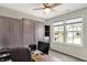 This office has built in cabinets and a desk, a ceiling fan and a window that looks out onto the street at 5850 Lyster Ln, Indianapolis, IN 46239