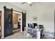 Functional home office featuring modern desk setup and stylish barn door access at 5850 Lyster Ln, Indianapolis, IN 46239