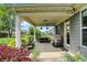 Covered outdoor patio seating area with overhead lighting and view of the backyard at 5850 Lyster Ln, Indianapolis, IN 46239