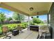 Covered outdoor patio with comfortable seating and dining area overlooking the beautiful backyard at 5850 Lyster Ln, Indianapolis, IN 46239