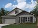 Charming single-story home with brick facade, covered entry, and landscaped front yard at 6024 Granby Dr, Whitestown, IN 46075